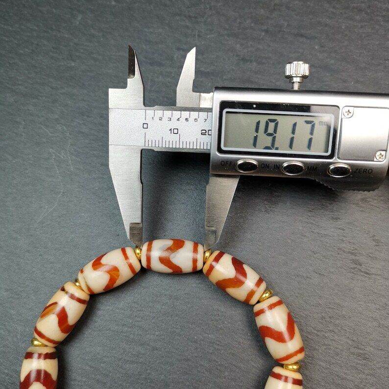 Fire Agate Tiger Tooth Dzi Bead Bracelet - Tibetan Buddhist mala beads, size reference