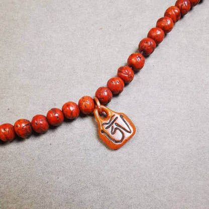 Yak Bone Carved OM Letter Prayer Bead Pendant - Tibetan Buddhist art, front view