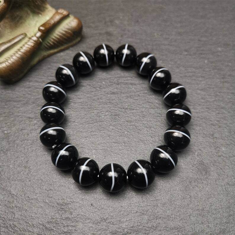 Black Agate Prayer Beads Bracelet - Tibetan Buddhist art, close-up detail