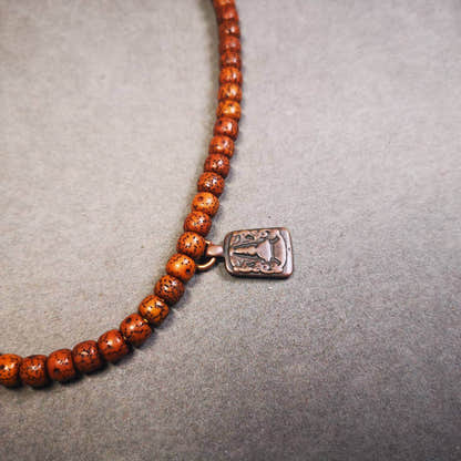 Mala Counter Pendant,Stupa, Pagoda - Tibetan Buddhist mala beads, close-up detail