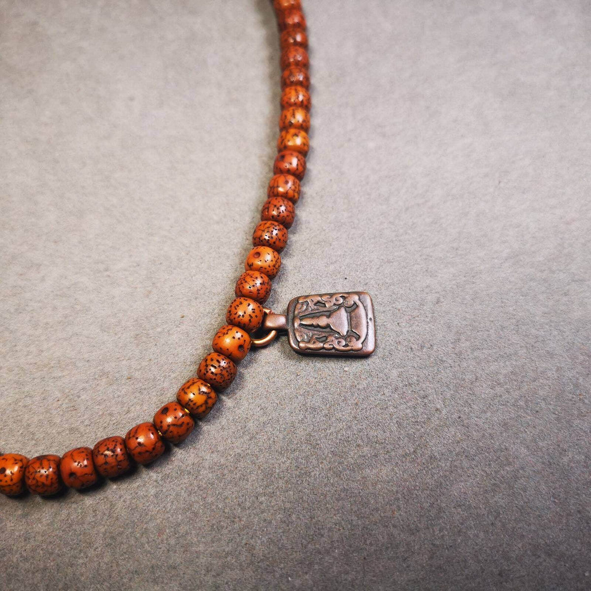 Mala Counter Pendant,Stupa, Pagoda - Tibetan Buddhist mala beads, close-up detail