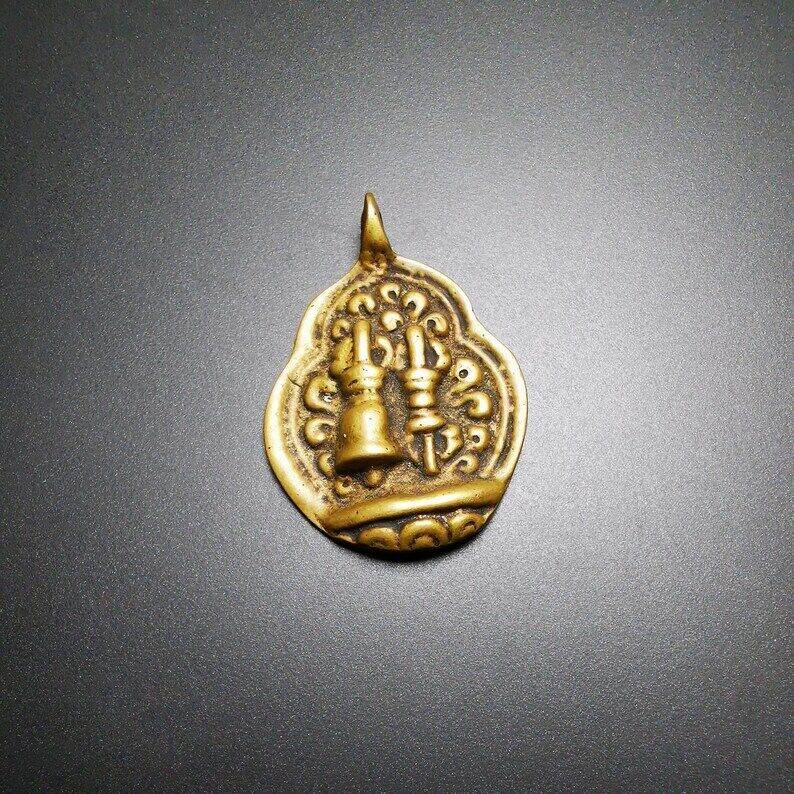 Buddhist Amulet,vajra club and tribu bell Pendant - Tibetan Buddhist amulet, close-up detail