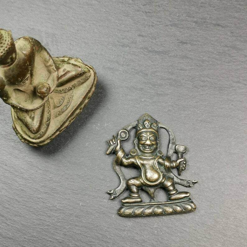 Tibetan Buddhist Statue,Mahakala Holding a Drum - Tibetan Buddhist statue, close-up detail