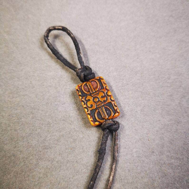 Buddhism Vajra Pendant,Hand Carved Yak Bone Dorje Amulet - Tibetan Buddhist amulet, close-up detail