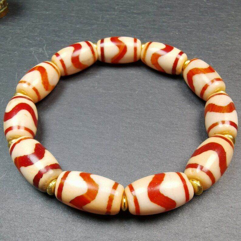 Fire Agate Tiger Tooth Dzi Bead Bracelet - Tibetan Buddhist mala beads, close-up detail