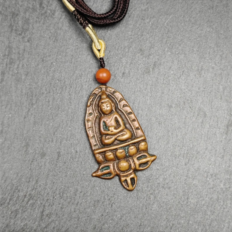 Tibetan Buddhist Amulet - Tibetan Buddhist amulet, close-up detail
