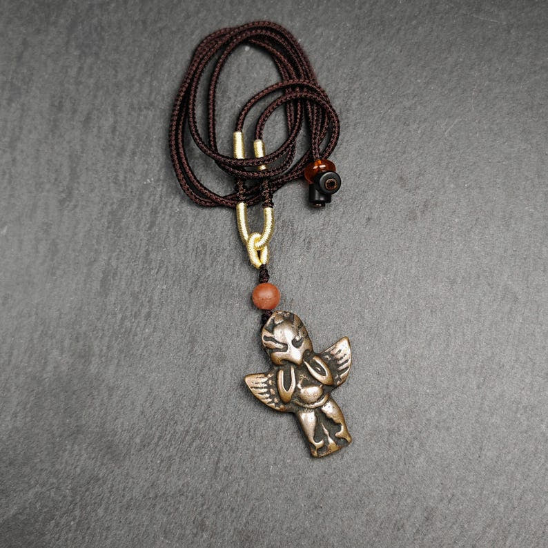 Tibetan Buddhist Amulet Pendant - Tibetan Buddhist amulet, close-up detail