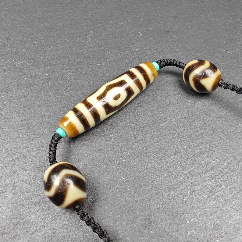 3 Eyes Dzi + Wave Dzi Beads Amulet - Tibetan Buddhist bead necklace, close-up detail