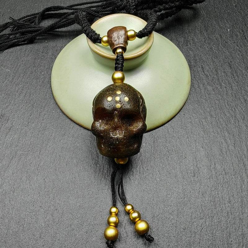 Amulet,Citipati Skull Charm - Tibetan Buddhist amulet, close-up detail