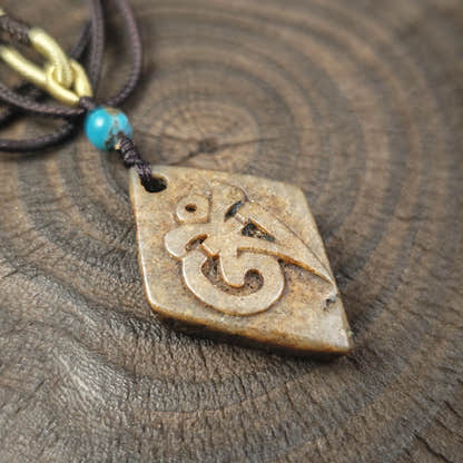 Kapala Amulet Pendant - Hum Syllable - Tibetan Buddhist amulet, detailed view