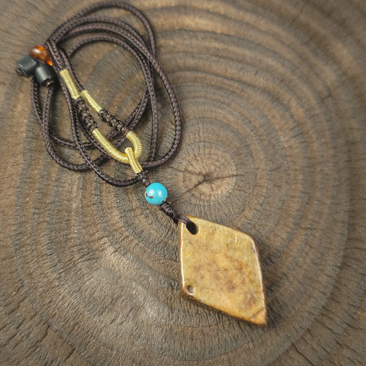 Kapala Amulet Pendant - Hum Syllable - Tibetan Buddhist amulet, close-up detail