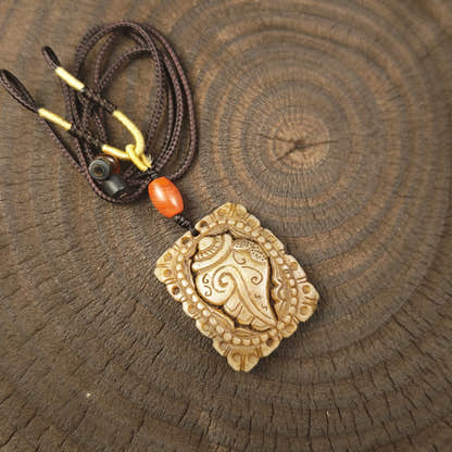 Kapala Amulet Pendant - Conch Shell - Tibetan Buddhist amulet, front view