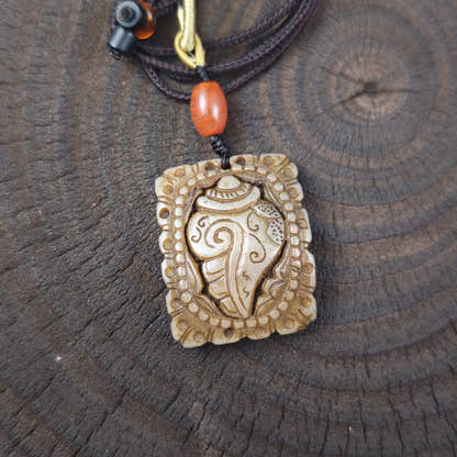 Kapala Amulet Pendant - Conch Shell - Tibetan Buddhist amulet, close-up detail