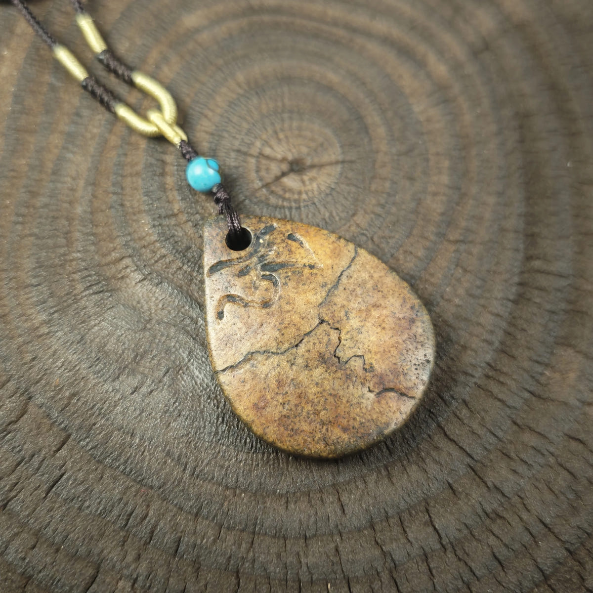Kapala Amulet Pendant - Hum Syllable - Tibetan Buddhist amulet, close-up detail