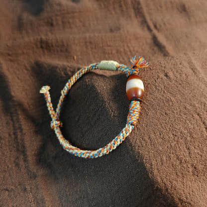 Hand Woven Bracelet with Fire Agate Tibetan Stripe Dzi Beads - Tibetan dzi bead, front view