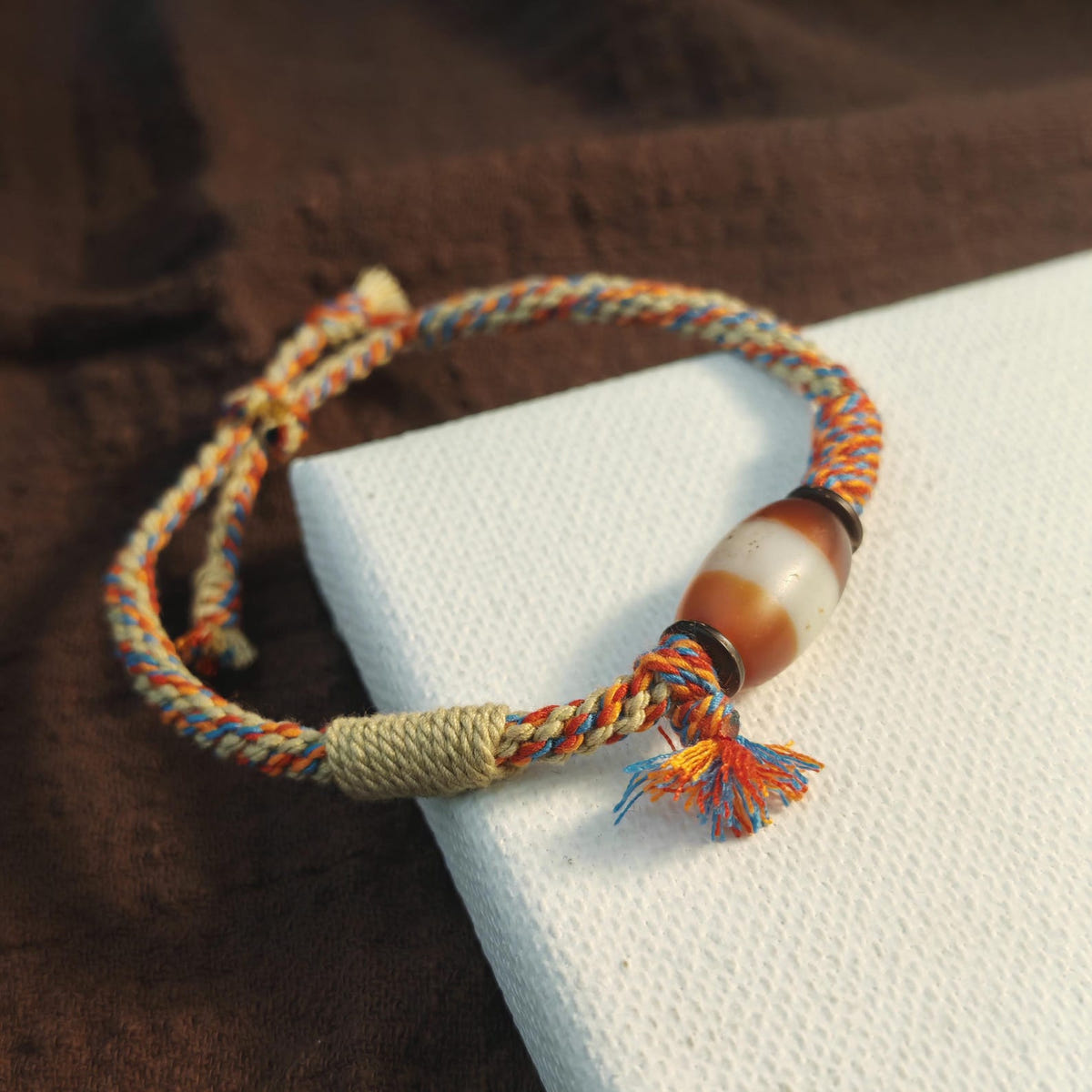 Hand Woven Bracelet with Fire Agate Tibetan Stripe Dzi Beads - Tibetan dzi bead, close-up detail