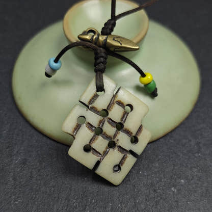Handcarved Yak Bone Lucky Knot Amulet / Endless Knot Pendant - Tibetan Buddhist amulet, detailed view