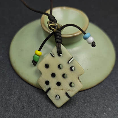 Handcarved Yak Bone Lucky Knot Amulet / Endless Knot Pendant - Tibetan Buddhist amulet, close-up detail
