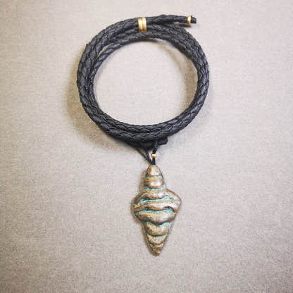 Shankha Divine Conch Badge,Tibetan Buddhist Protective Amulet Pendant,Made of Li - Tibetan Buddhist amulet, close-up detail