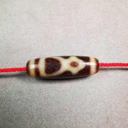 Kubera Dzi Bead - Tibetan dzi bead, front view