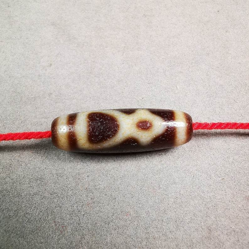 Kubera Dzi Bead - Tibetan dzi bead, front view