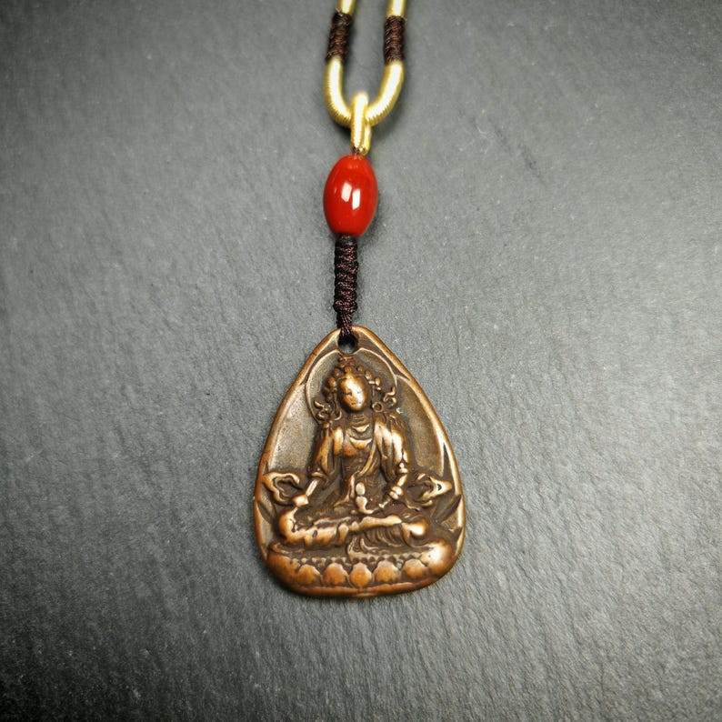 Statue Amulet,Green Tara Pendant - Tibetan Buddhist amulet, close-up detail