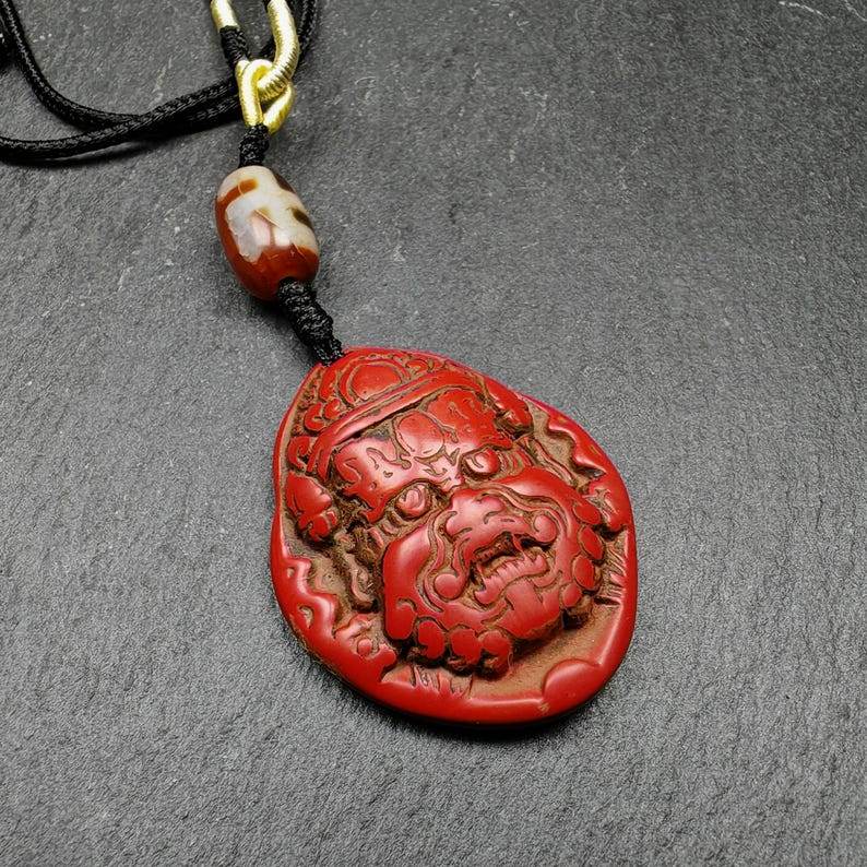 Old Cinnabar Mahakala Amulet with Dzi Bead - Tibetan dzi bead, front view