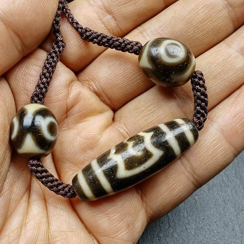 Tibetan Dzi Necklace - Garuda Dzi + 3 Eyes Dalo Dzi Amulet - Tibetan Buddhist bead necklace, close-up detail