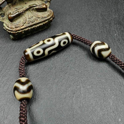 Tibetan Dzi Necklace,9 Eyes Dzi + 2 Wave Darlo Dzi Beads Amulet - Tibetan Buddhist bead necklace, close-up detail