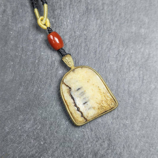 Shield-shaped Kapala Amulet - 33mm - Tibetan Buddhist amulet, front view