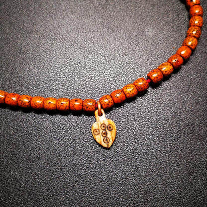 Bone Carved Nubro Pendant - Tibetan Buddhist art, close-up detail