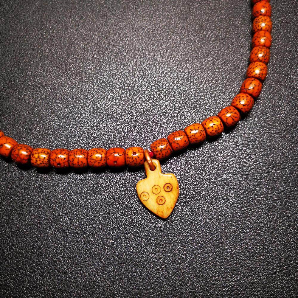 Bone Carved Nubro Pendant - Tibetan Buddhist art, detailed view