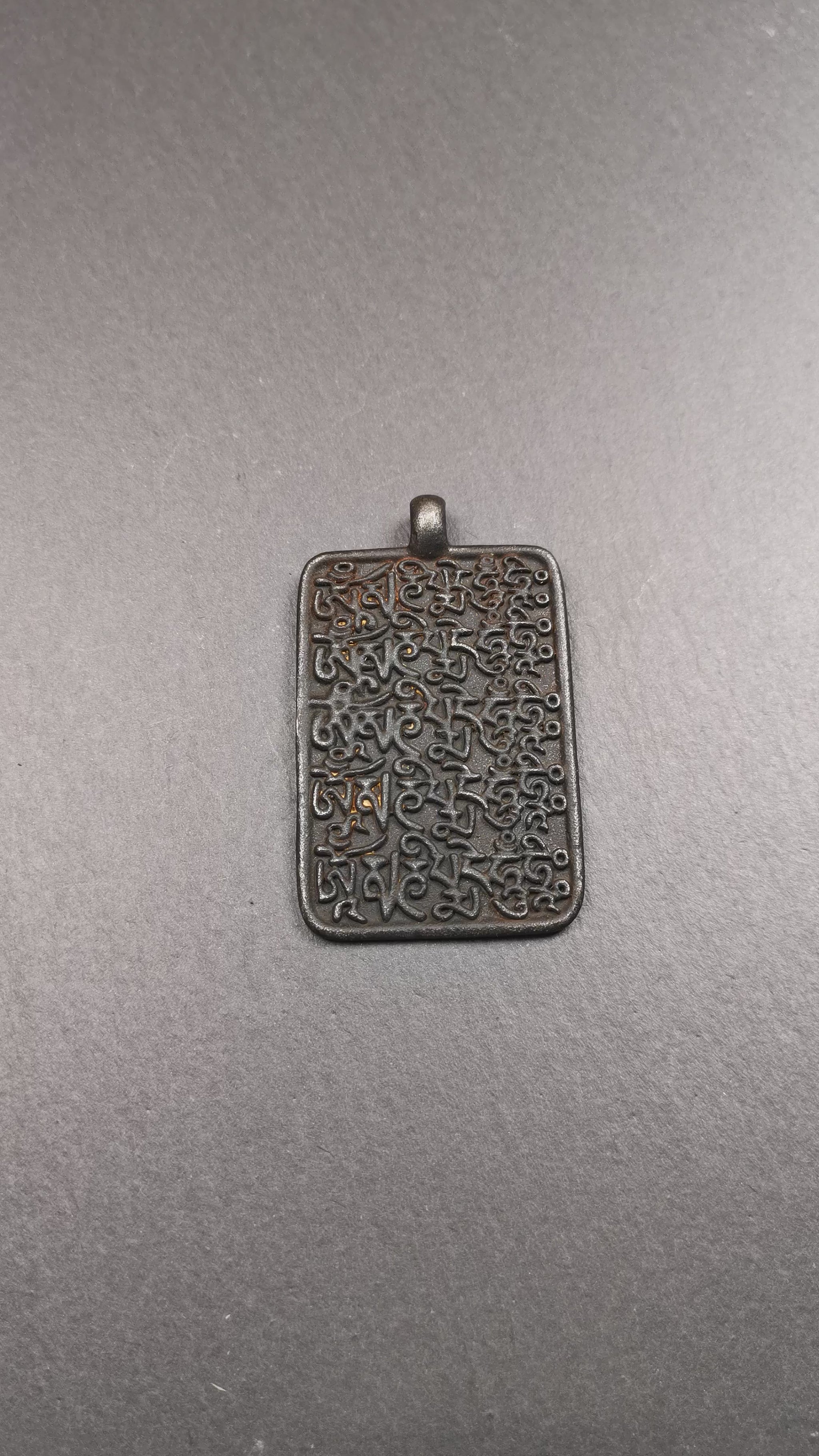 This badge is made by Tibetan craftsmen from Hepo Town, Baiyu County, the birthplace of the famous Tibetan handicrafts. It is made of copper, 2.52 × 1.57 inches. The front is the OM mantra and the back is body, speech, and mind.