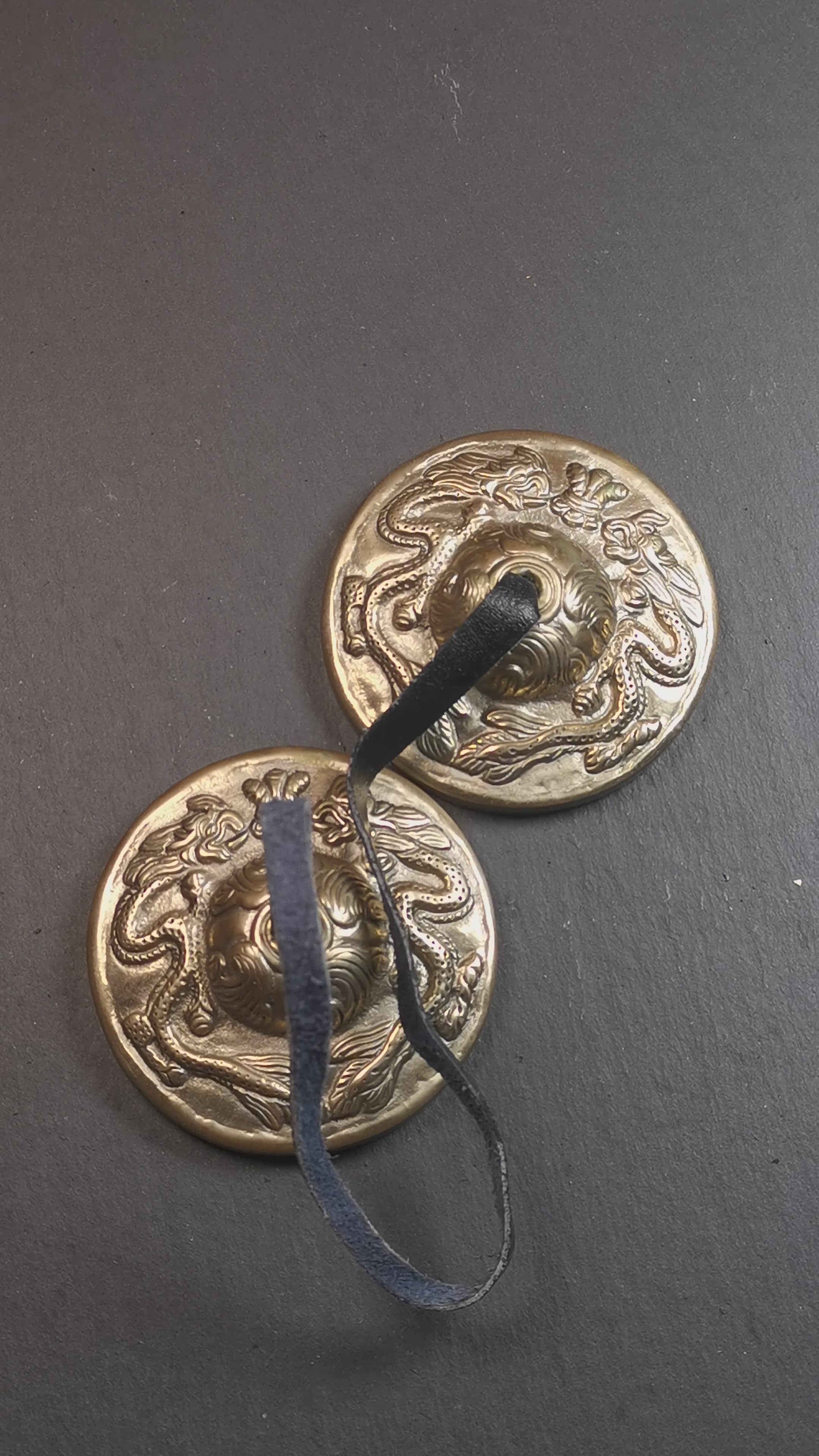 This tingsha bell set was handmade in Nepal,using traditional techniques and materials. It was made of bronze,carved om mani padme hum mantra,6.8cm diameter,with pure, clear and resonant,good for meditation. Come with tingsha case.