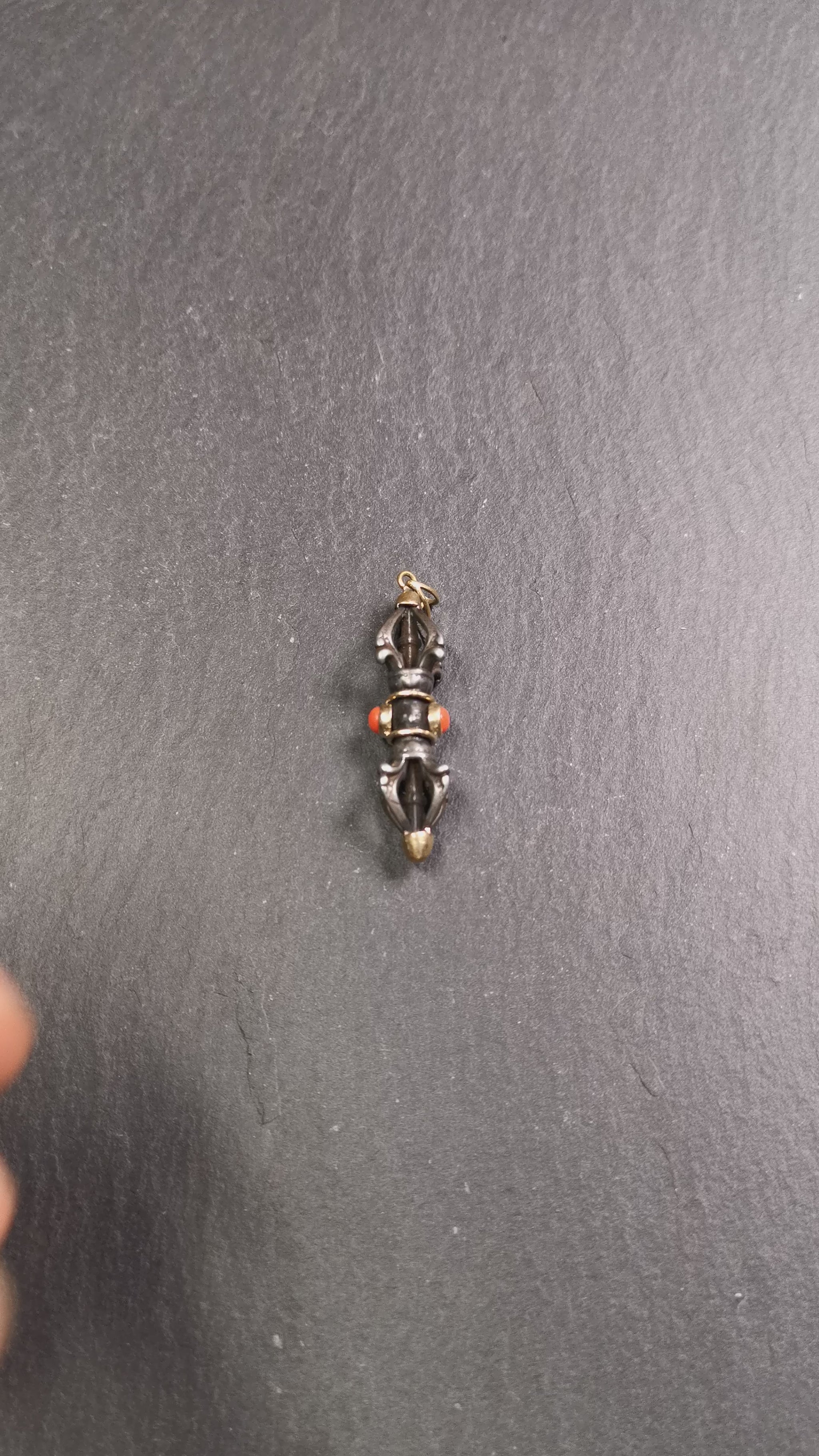 This unique vajra pendant was handmade by Tibetan craftsmen from Tibet in 1990's,from Hepo Town, Baiyu County, the birthplace of the famous Tibetan handicrafts. It is five-pronged Vajra,made of cold iron, 1.77 inch height.Comes with leather cord. You can make it a necklace, pendant, keychain, mala pendant, or just as an ornament on your desk.