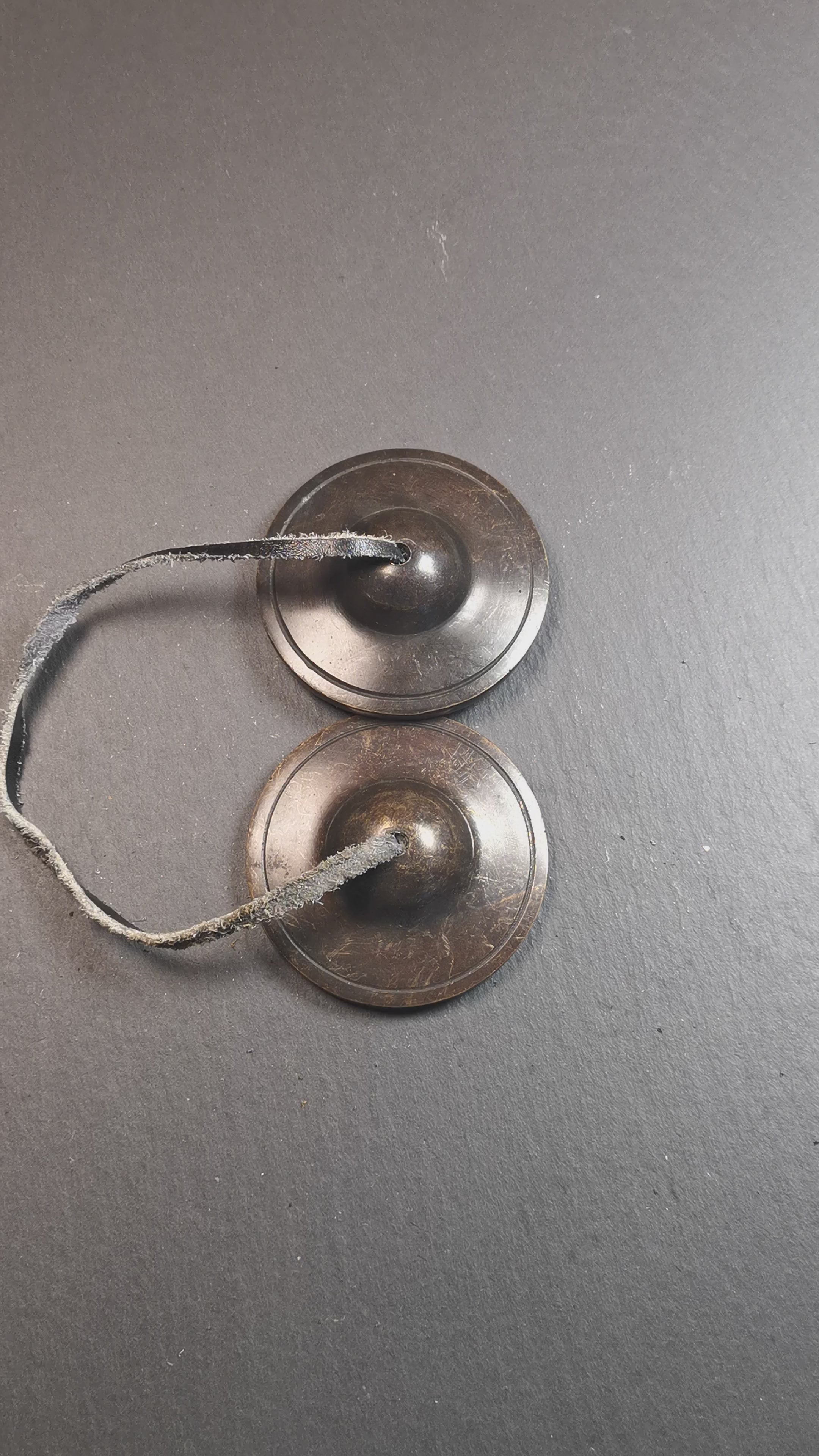 This tingsha bell set was handmade in Nepal,using traditional techniques and materials. It was made of brass,dark color,6.5cm diameter,with pure, clear and resonant,good for meditation. Come with tingsha case.