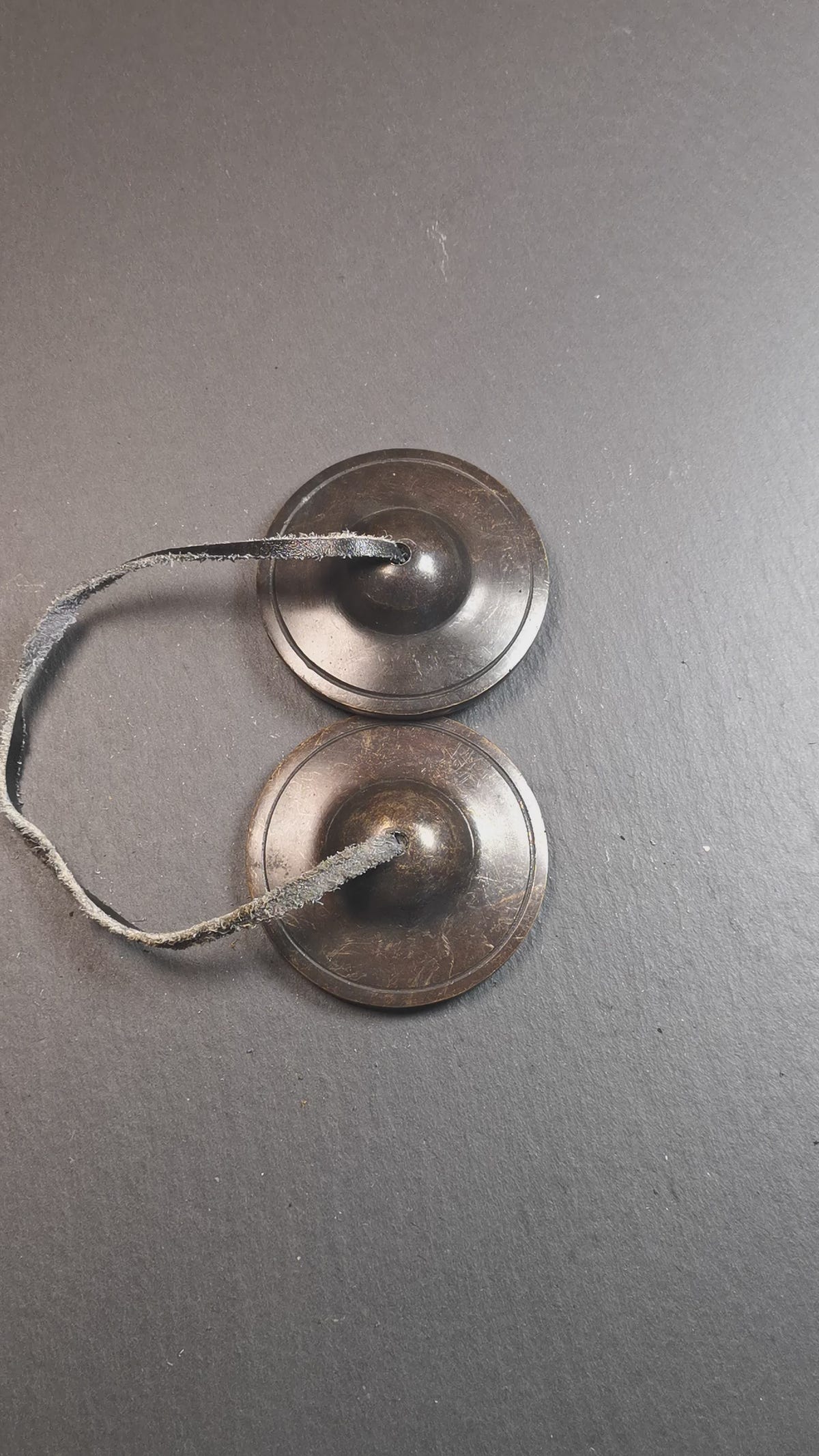 This tingsha bell set was handmade in Nepal,using traditional techniques and materials. It was made of brass,dark color,6.5cm diameter,with pure, clear and resonant,good for meditation. Come with tingsha case.