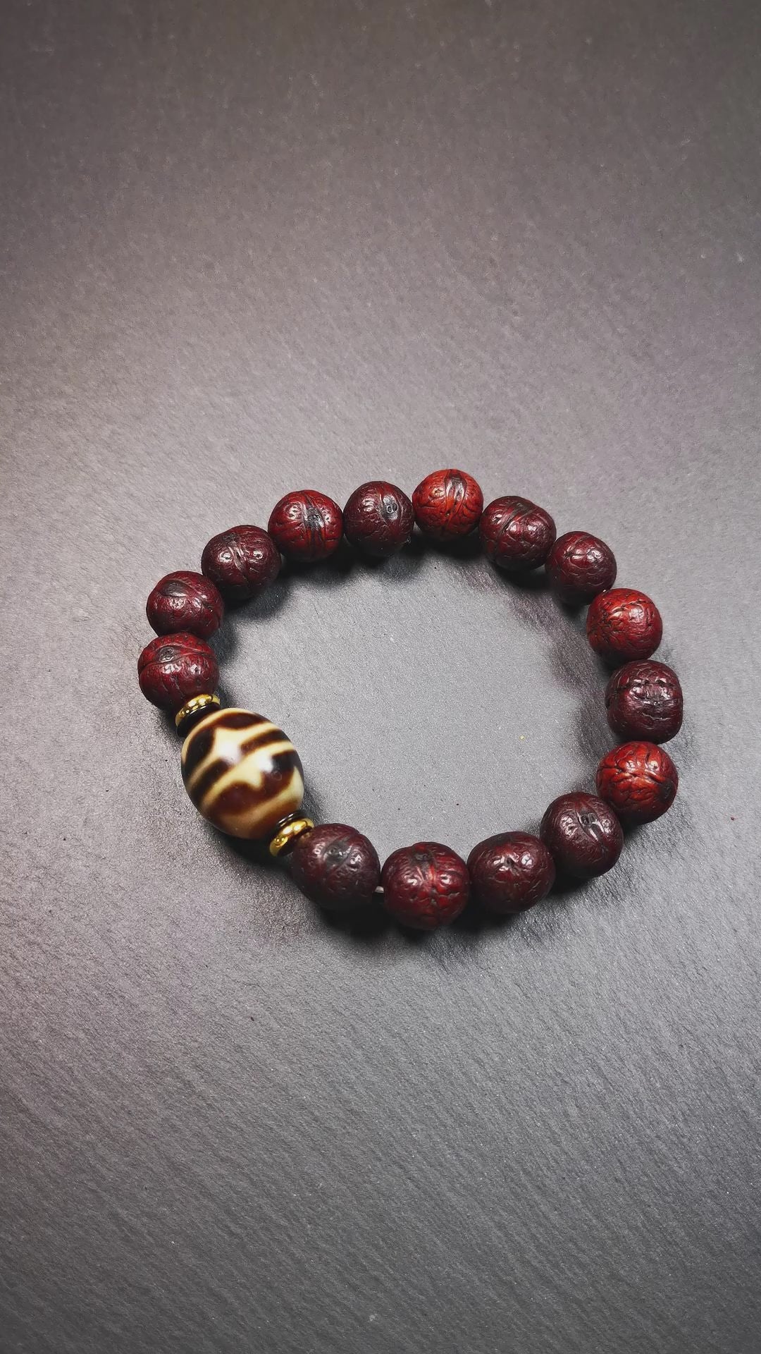 This unique Dalo Dzi bracelet combines the mysterious and unique qualities of the tiger tooth dalo dzi and 15 old bodhi seed beads,giving it a distinct feel.  It is brown in color and has a circumference of approximately 7 inches, suitable for most wrist sizes. 