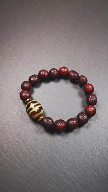 This unique Dalo Dzi bracelet combines the mysterious and unique qualities of the tiger tooth dalo dzi and 15 old bodhi seed beads,giving it a distinct feel.  It is brown in color and has a circumference of approximately 7 inches, suitable for most wrist sizes. 