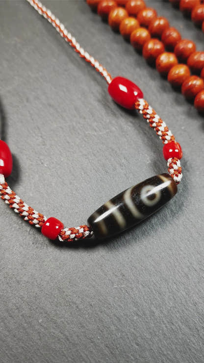 This necklace was hand-woven by Tibetans from Baiyu County, the main bead is a 2 eyed dzi bead, paired with agate beads,about 30 years old. It can be worn as a fashionable accessory, also holds cultural and religious significance.