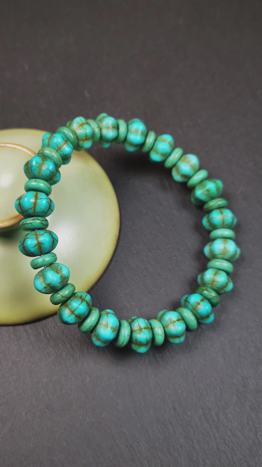 This beautiful turquoise bracelet is handmade from Tibet in 1980's. It's green color, made of turquoise, 19 hexagon beads and 19 spacer beads in total,7.4 inches circumference,0.47 width.
