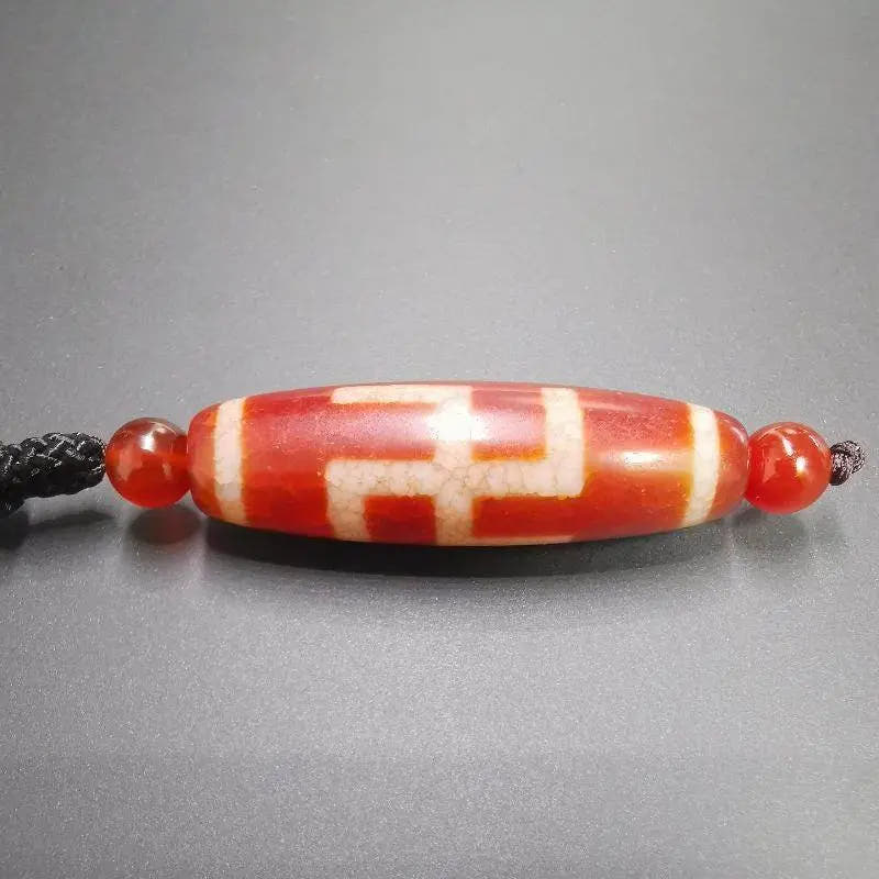 Fire Agate Swastika Symbol 卐 Dzi Beads - Tibetan dzi bead, detailed view